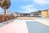 Vibrant outdoor recreational area featuring colorful geometric flooring with a backdrop of modern residential apartments.