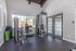 Bright and airy home gym with modern fitness equipment and floor-to-ceiling windows for natural light.