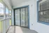 Charming balcony with sliding glass doors and calming views, perfect for relaxation and enjoying outdoor living.