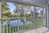 Charming balcony view of a serene pond and lush green landscape in a tranquil residential community.