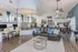 Modern open-concept living space with stylish decor, featuring a cozy seating area, elegant dining setup, and a spacious kitchen with a sleek design.