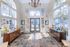 Elegant and inviting entrance with high ceilings, large arched windows, and stylish tile flooring, creating a bright and welcoming atmosphere.