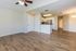 Inviting open-concept apartment with modern kitchen, sleek countertops, and elegant wood flooring.