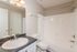 Bright and modern bathroom featuring a sleek sink, elegant countertop, and a spacious bathtub.