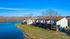 Charming lakefront apartments with scenic views, featuring spacious back decks and lush green surroundings for serene living.