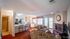 Cozy living room with plush sofas, a warm fireplace, and a modern open kitchen, ideal for relaxed living.