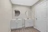 Modern bathroom with dual vanities, circular mirrors, and sleek cabinetry, offering a stylish and functional space.