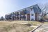 Charming apartment complex with stylish balconies and modern architectural design, offering a peaceful residential setting.