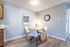 Cozy dining area with modern round table, elegant chairs, and stylish decor in a bright apartment corner.