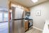 Chic kitchen featuring stainless steel appliances, elegant wooden cabinets, and a cozy atmosphere with abundant natural light.