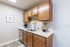 Charming kitchen with sleek wooden cabinets, modern appliances, and a stylish countertop accentuated by curated decor.