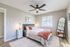Bright and inviting bedroom with a plush bed, modern decor, and large window showcasing natural light.