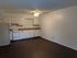 Charming apartment kitchen with ample cabinetry, sleek countertops, and cozy dining area in an open layout.