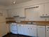 Bright, classic kitchen featuring ample counter space, white cabinetry, and modern appliances.