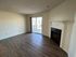 Inviting living room with elegant hardwood floors, a cozy fireplace, and abundant natural light from sliding glass doors.
