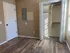 Inviting bedroom with elegant wood flooring, ample closet space, and abundant natural light from large windows.