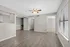 Bright and inviting living space featuring modern wood flooring, neutral paint, and ample natural light through large windows.