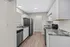Modern kitchen with sleek countertops, stainless steel appliances, and white cabinetry, offering a stylish cooking space.