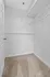 Spacious walk-in closet with modern wire shelving and soft carpet flooring, ideal for organizing your wardrobe efficiently.