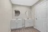 Modern double vanity bathroom with sleek fixtures, elegant round mirrors, and laminate flooring for a chic, contemporary look.