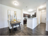 Contemporary open-plan dining and kitchen area with stylish decor and sleek hardwood floors.