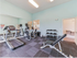 Inviting fitness center featuring modern gym equipment, spacious workout area, and vibrant ambiance.