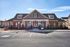 Inviting community clubhouse with charming architecture, enhanced by vibrant balloons, welcoming residents to modern living.