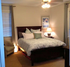 Cozy bedroom with elegant bed, plush pillows, and soft lighting, creating a serene and inviting atmosphere.