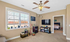 Inviting living room featuring natural light, cozy decor with plants, and a glimpse into a comfortable bedroom. Ideal for relaxation and leisure.