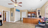 Charming open-plan apartment with cozy living area, modern kitchen, and inviting warm-toned decor.