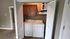 Convenient in-unit laundry with washer and dryer neatly tucked behind stylish folding doors, enhancing the apartment's functionality.