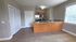 Bright kitchen area featuring sleek countertops, modern appliances, and ample cabinetry, perfect for culinary enthusiasts.