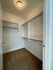 Spacious walk-in closet with ample shelving and hanging space, perfect for organizing your wardrobe.