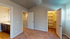 Inviting bedroom with plush carpet, walk-in closet, and stylish granite-topped vanity in the adjacent bath.