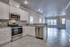 Elegant open-plan kitchen and living area with modern appliances, sleek cabinetry, and abundant natural light.