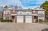 Charming two-story brick duplex with spacious garage, nestled in a serene neighborhood, perfect for comfortable family living.