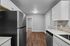 Modern kitchen with sleek stainless steel appliances, elegant cabinetry, and rich hardwood floors.