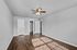 Charming room with elegant ceiling fan and rich wooden flooring, perfect for creating a cozy bedroom or office space.