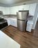 Modern kitchen with sleek stainless steel appliances, elegant white cabinetry, and chic subway tile backsplash.