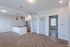 Bright and modern open-concept kitchen and living space featuring sleek pendant lighting and stylish wooden flooring.