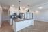 Chic modern kitchen with sleek countertops, stainless steel appliances, and elegant pendant lighting, perfect for culinary enthusiasts.