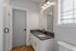 Bright and modern bathroom featuring a sleek vanity, large mirror with warm lighting, and stylish subway tile shower.