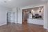 Modern apartment interior with sleek kitchen, hardwood floors, and ambient lighting creating a cozy and inviting atmosphere.