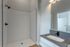 Sleek modern bathroom with elegant subway tile shower and stylish vanity with large mirror.