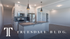 Modern kitchen with sleek countertops, stainless steel appliances, and elegant lighting in Truesdale Building.