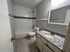 Modern bathroom featuring elegant white subway tiles, a sleek granite countertop, and stylish fixtures for a sophisticated look.