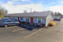 Charming single-story apartment complex with festive decorations and convenient parking, perfect for comfortable living.