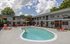 Charming courtyard view with an inviting pool, modern lounge chairs, and string lights, perfect for relaxation and social gatherings.