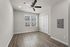 Bright, modern room featuring elegant wood flooring and a sleek ceiling fan, perfect for a cozy home setting.