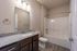Elegant bathroom with granite countertop, modern fixtures, and sleek bathtub design offers a relaxing retreat.